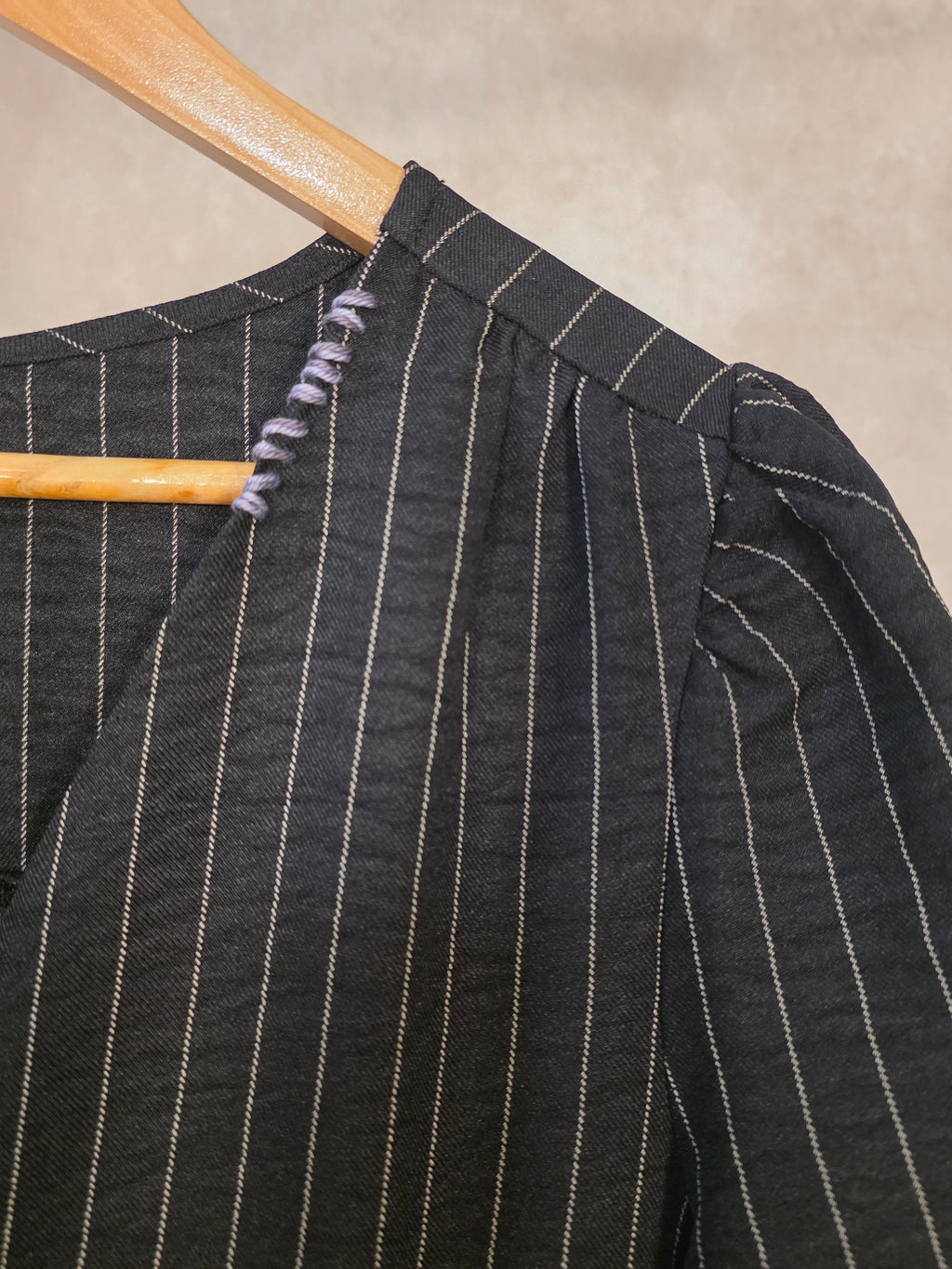 Abito gessato nero con scollo a V