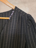 Abito gessato nero con scollo a V