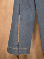 Jeans a gamba larga con lacci intrecciati